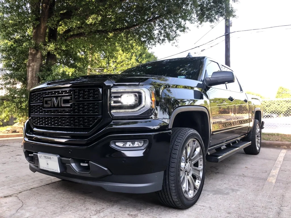 Black GMC truck featuring a clean, glossy professional auto wrap done in San Antonio